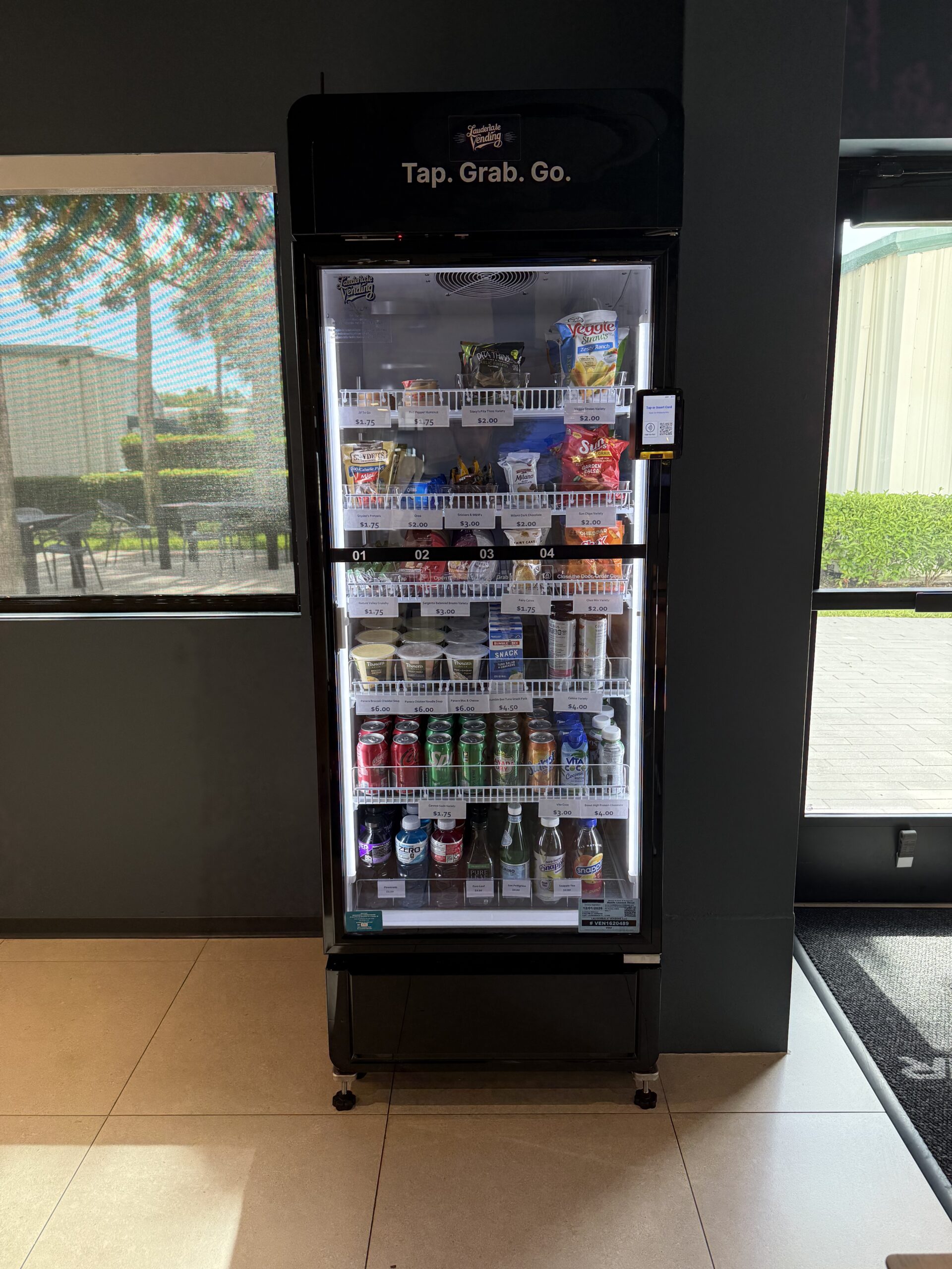 Fully stocked AI smart cooler at an FXE FBO lobby